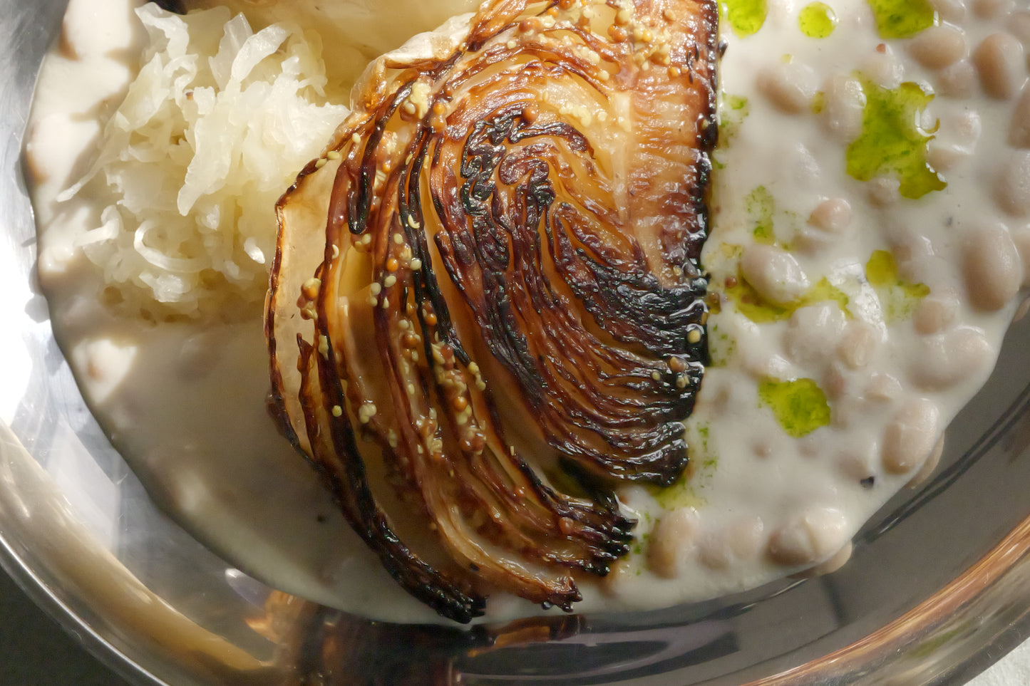 Roasted Cabbage with Tofu–Olive Oil Cream, White Beans, Sauerkraut, Parsley Oil & Dijon Mustard