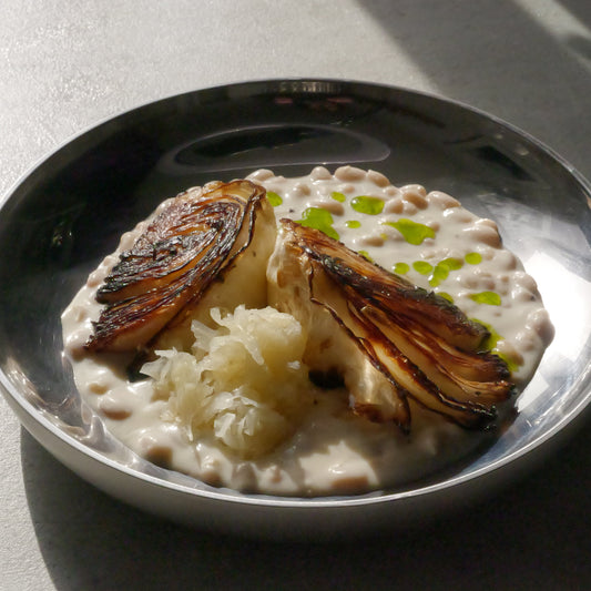 beans with roasted cabbage on a silver plate
