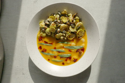 Butternut Squash Brothy Beans with Crispy Brussels Sprouts, Estragon, Szechuan Chili Oil & Toasted Seeds