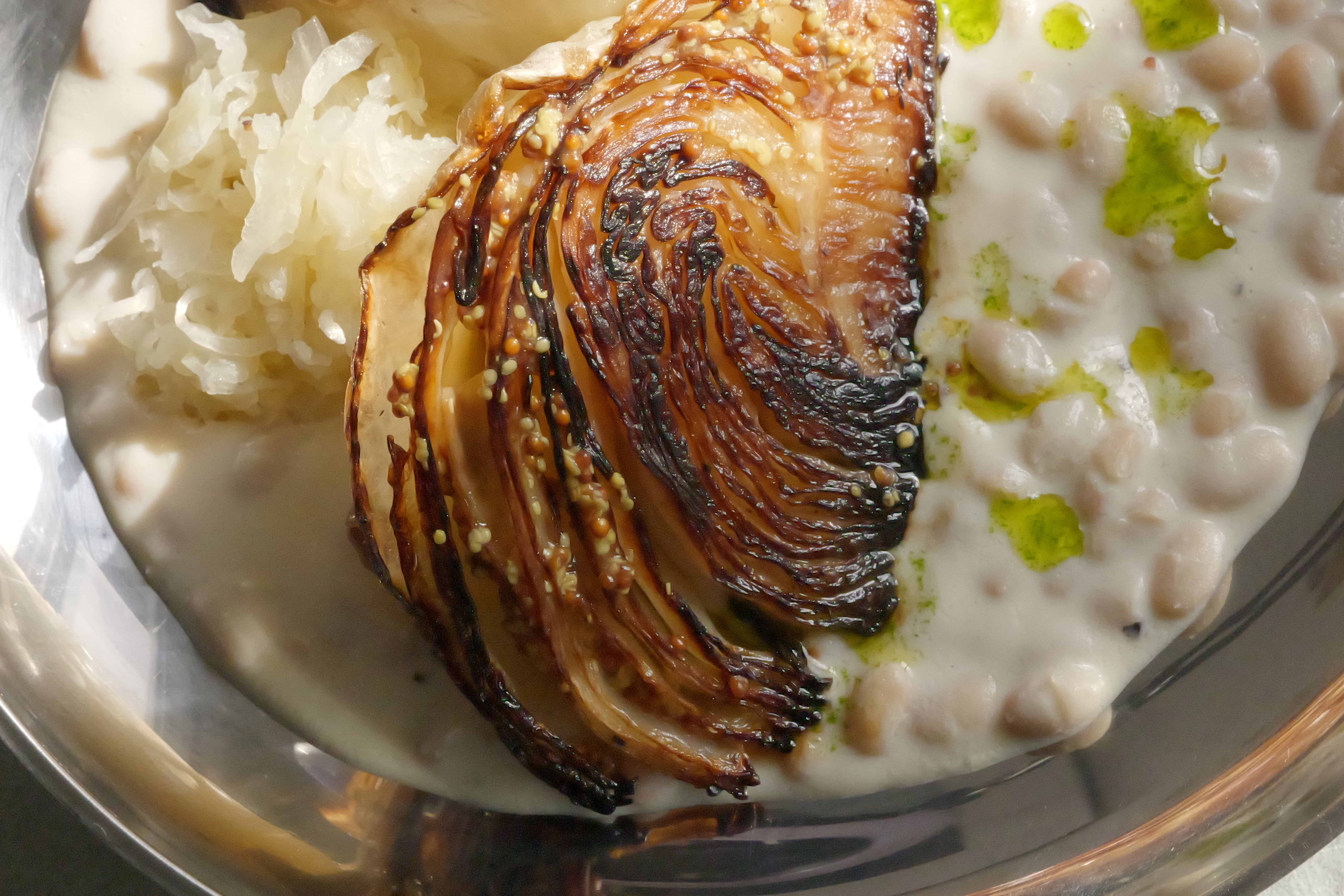 Image of Roasted Cabbage with Tofu–Olive Oil Cream, White Beans, Sauerkraut, Parsley Oil & Dijon Mustard