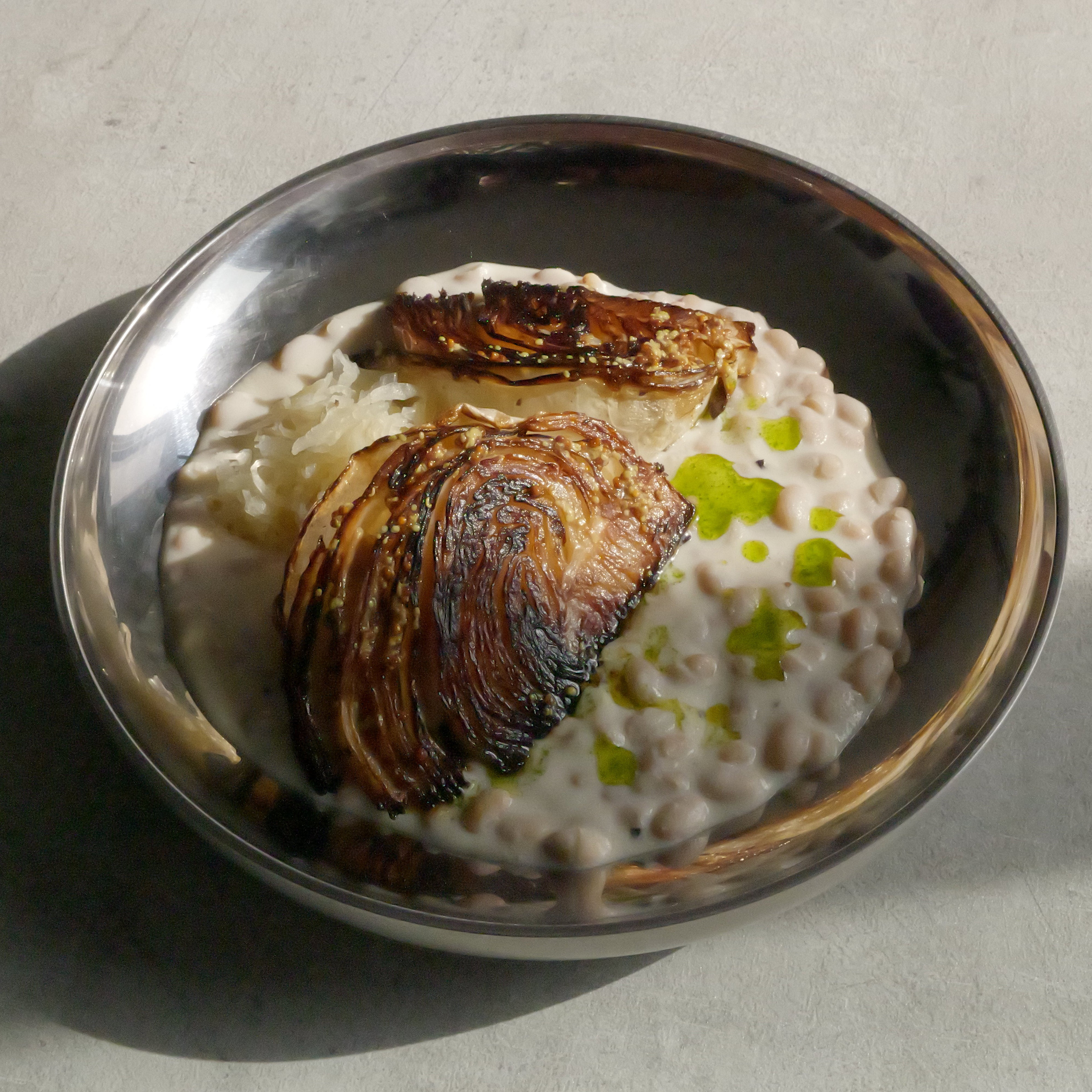 Image of Roasted Cabbage with Tofu–Olive Oil Cream, White Beans, Sauerkraut, Parsley Oil & Dijon Mustard