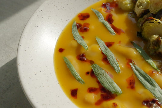 Butternut Squash Brothy Beans with Crispy Brussels Sprouts, Estragon, Szechuan Chili Oil & Toasted Seeds