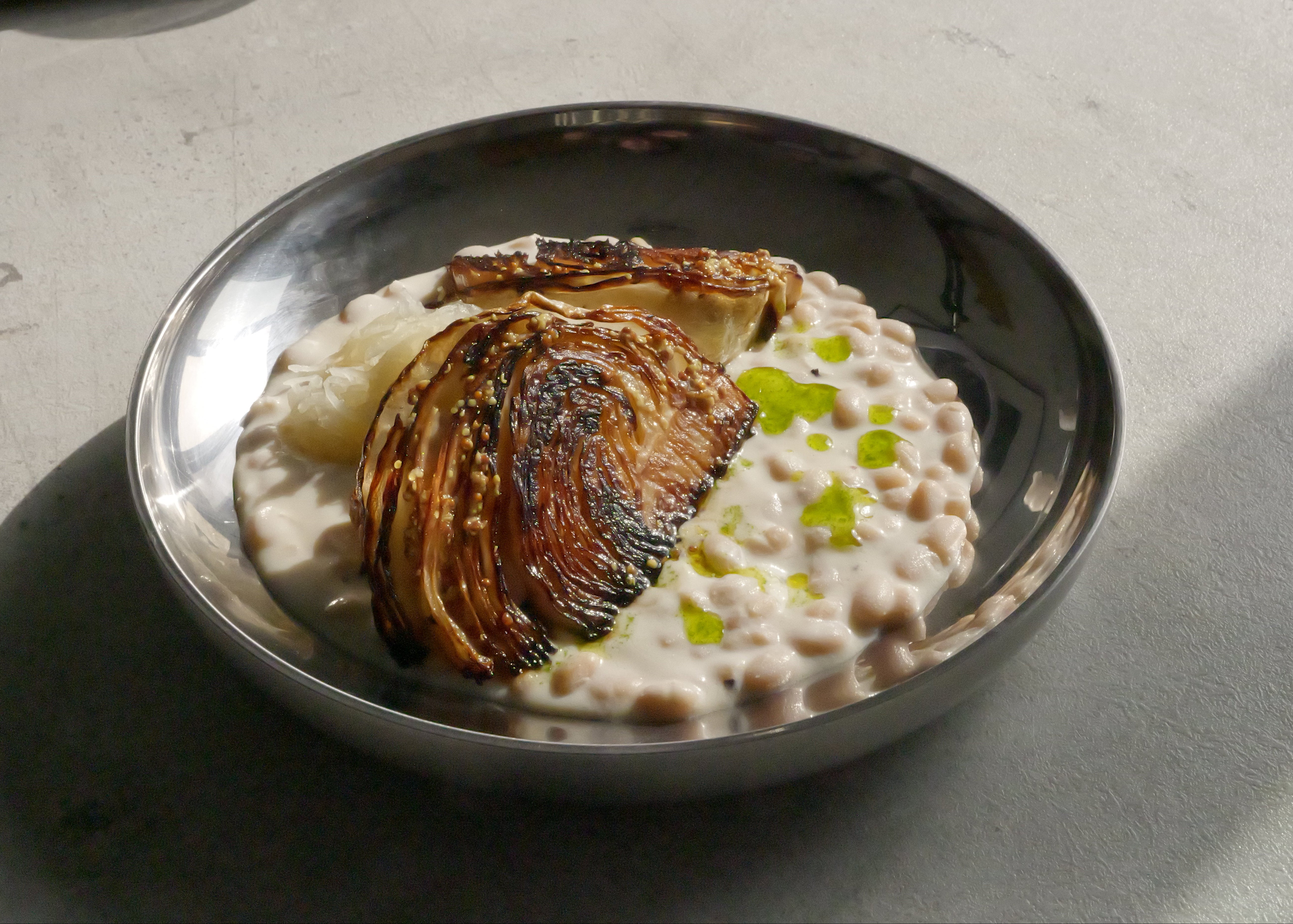 Image of Roasted Cabbage with Tofu–Olive Oil Cream, White Beans, Sauerkraut, Parsley Oil & Dijon Mustard