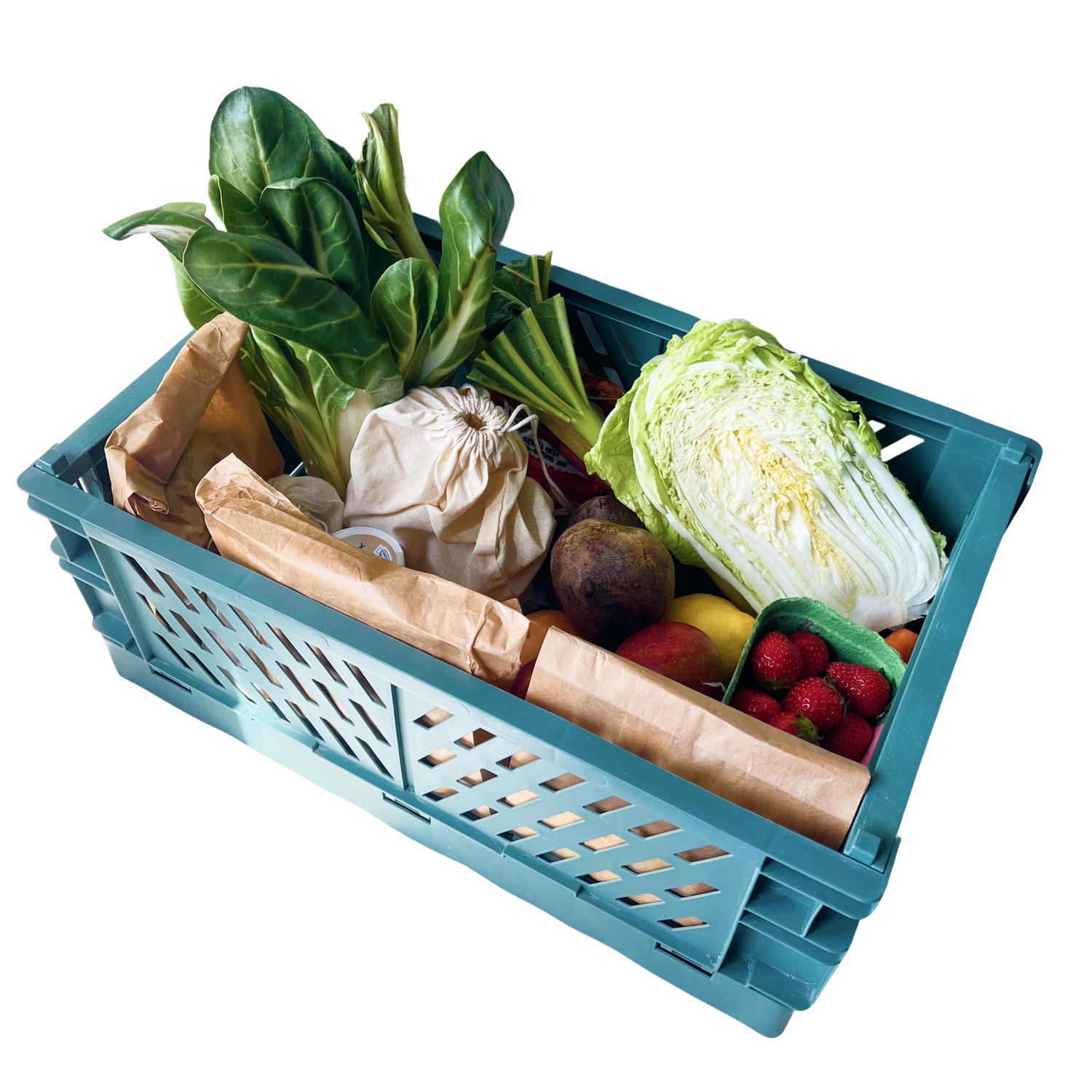 Teal crate filled with fresh vegetables on a white background