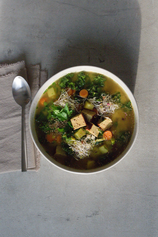 Golden Turmeric Kale Soup with Sesame Smoked Tofu and Sprouts