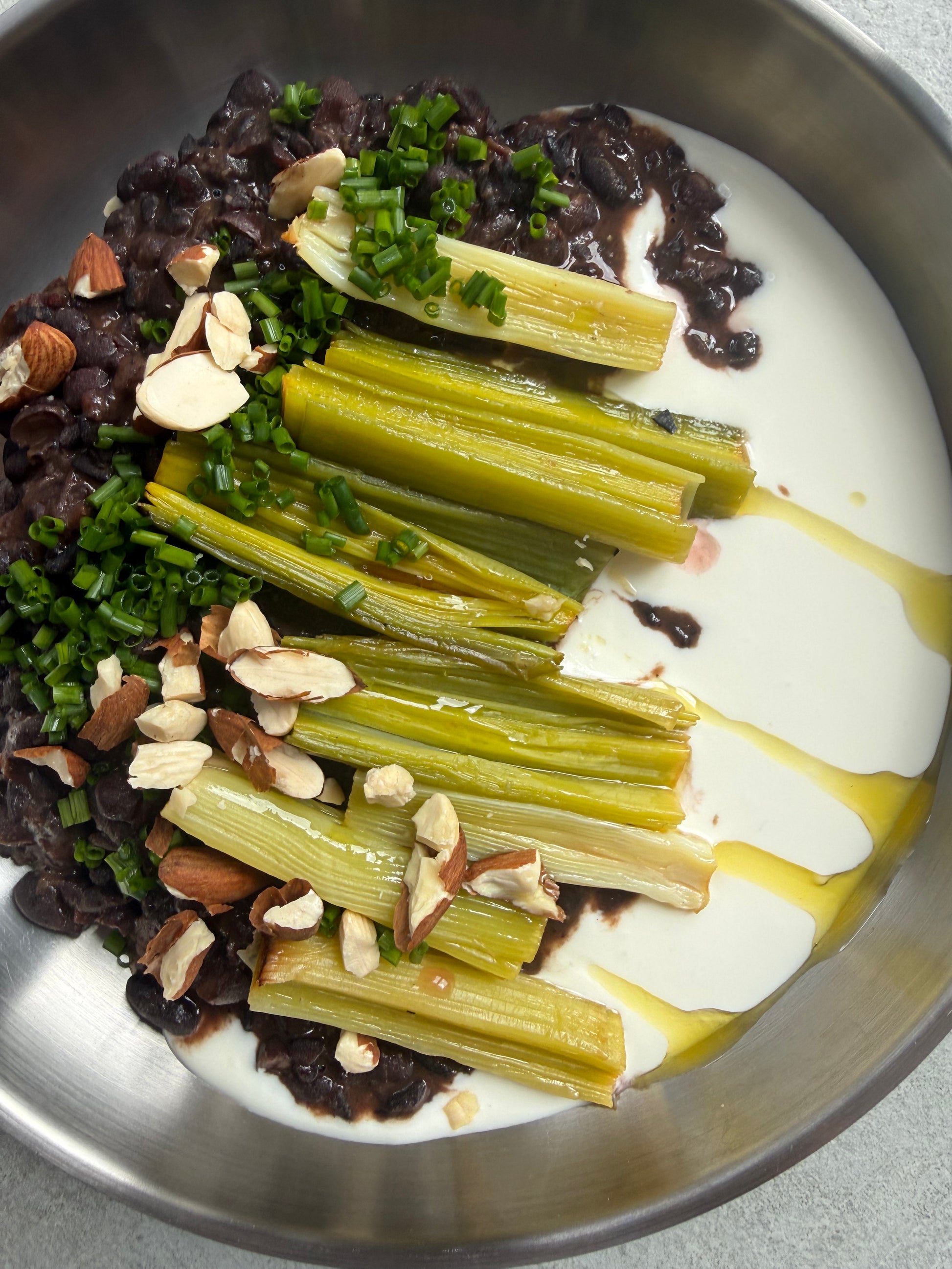Velvety Cacao & Cumin Black Beans with Sweet Tajine-Style Plums, Charred Leek & Whipped Goat Cheese