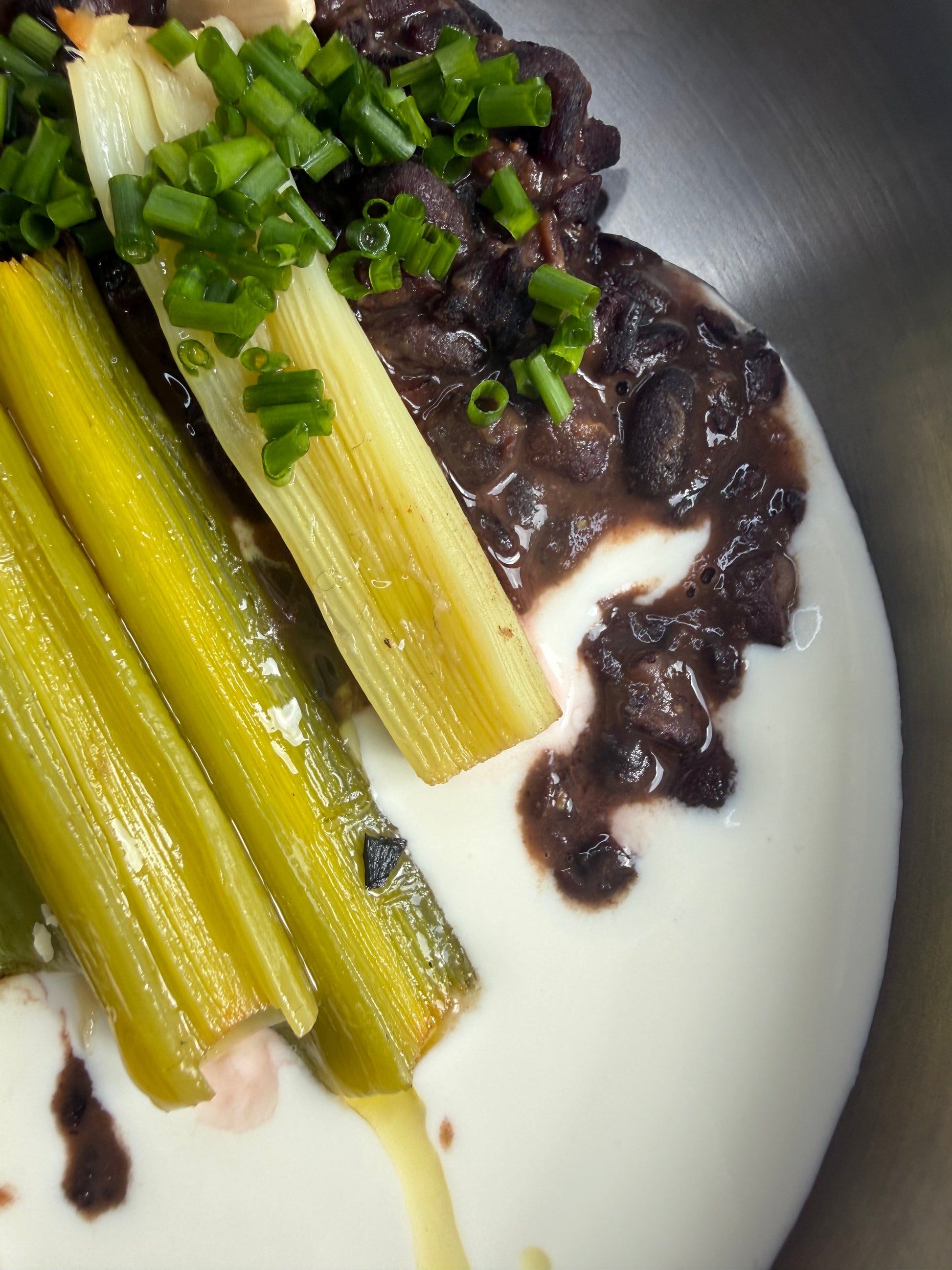 Velvety Cacao & Cumin Black Beans with Sweet Tajine-Style Plums, Charred Leek & Whipped Goat Cheese