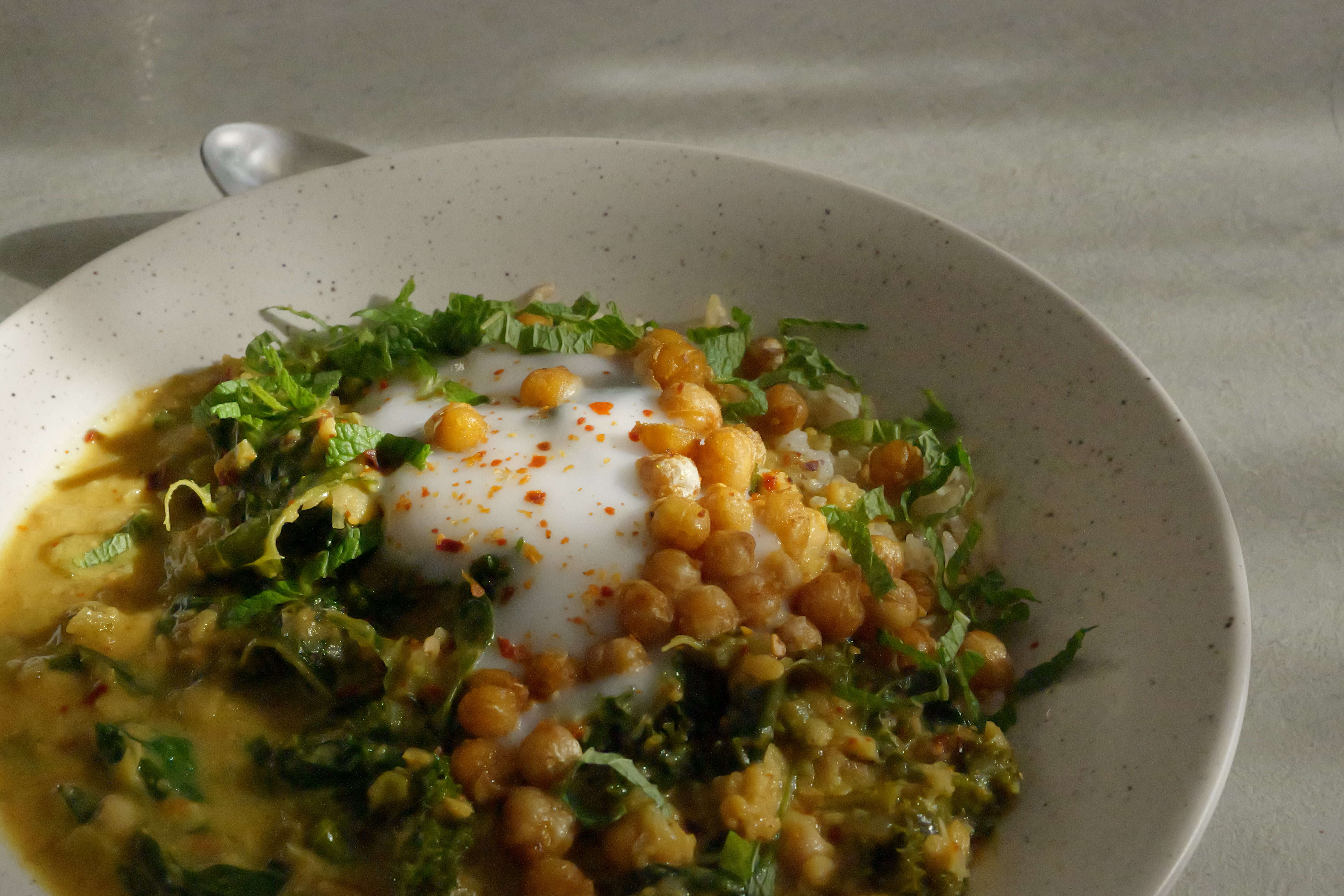 Image of Healing Chickpea Stew with Seasonal Leafy Greens, Wholegrain Basmati Rice, Coconut Yogurt & Anti-Inflammatory Tadka