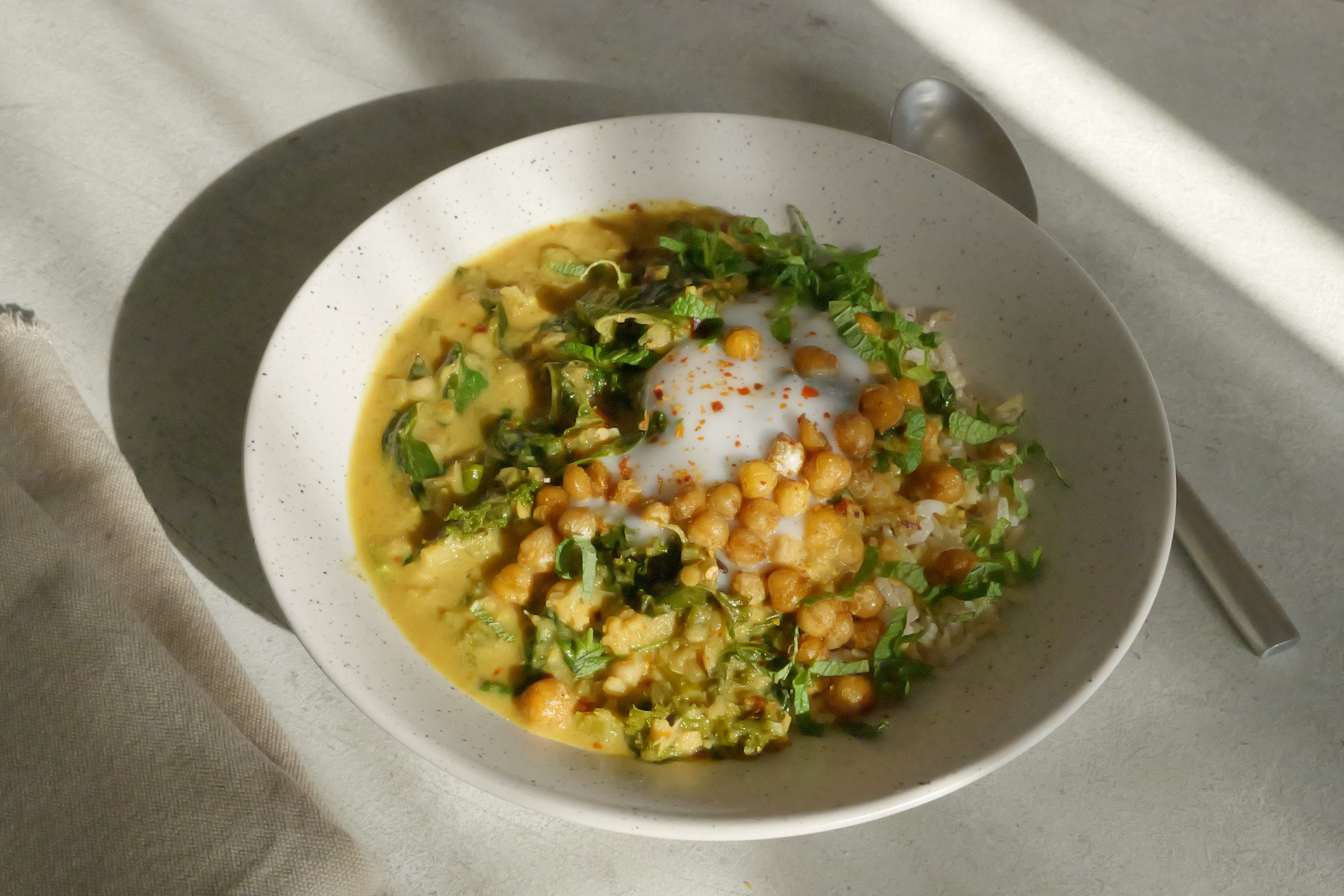 Image of Healing Chickpea Stew with Seasonal Leafy Greens, Wholegrain Basmati Rice, Coconut Yogurt & Anti-Inflammatory Tadka