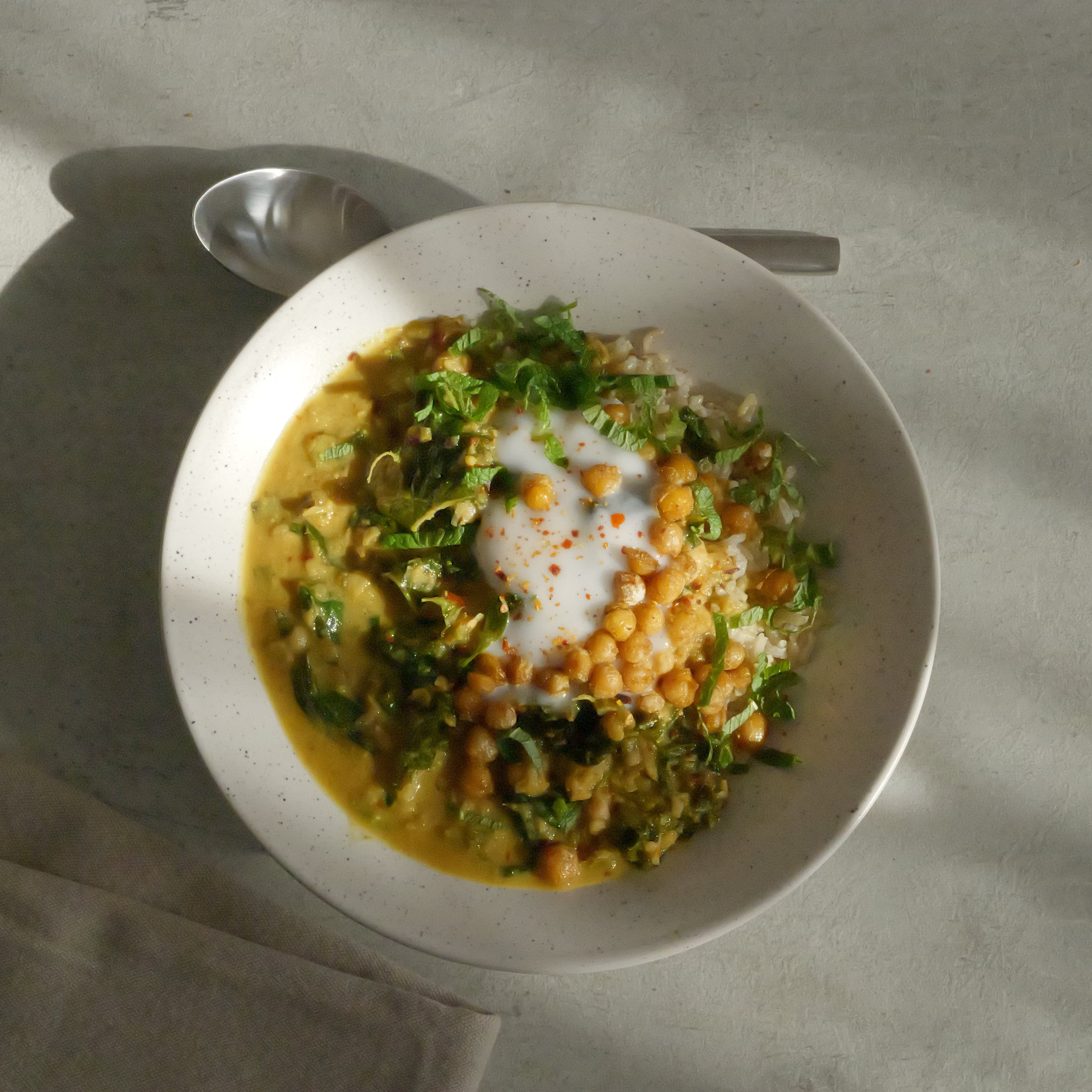Image of Healing Chickpea Stew with Seasonal Leafy Greens, Wholegrain Basmati Rice, Coconut Yogurt & Anti-Inflammatory Tadka