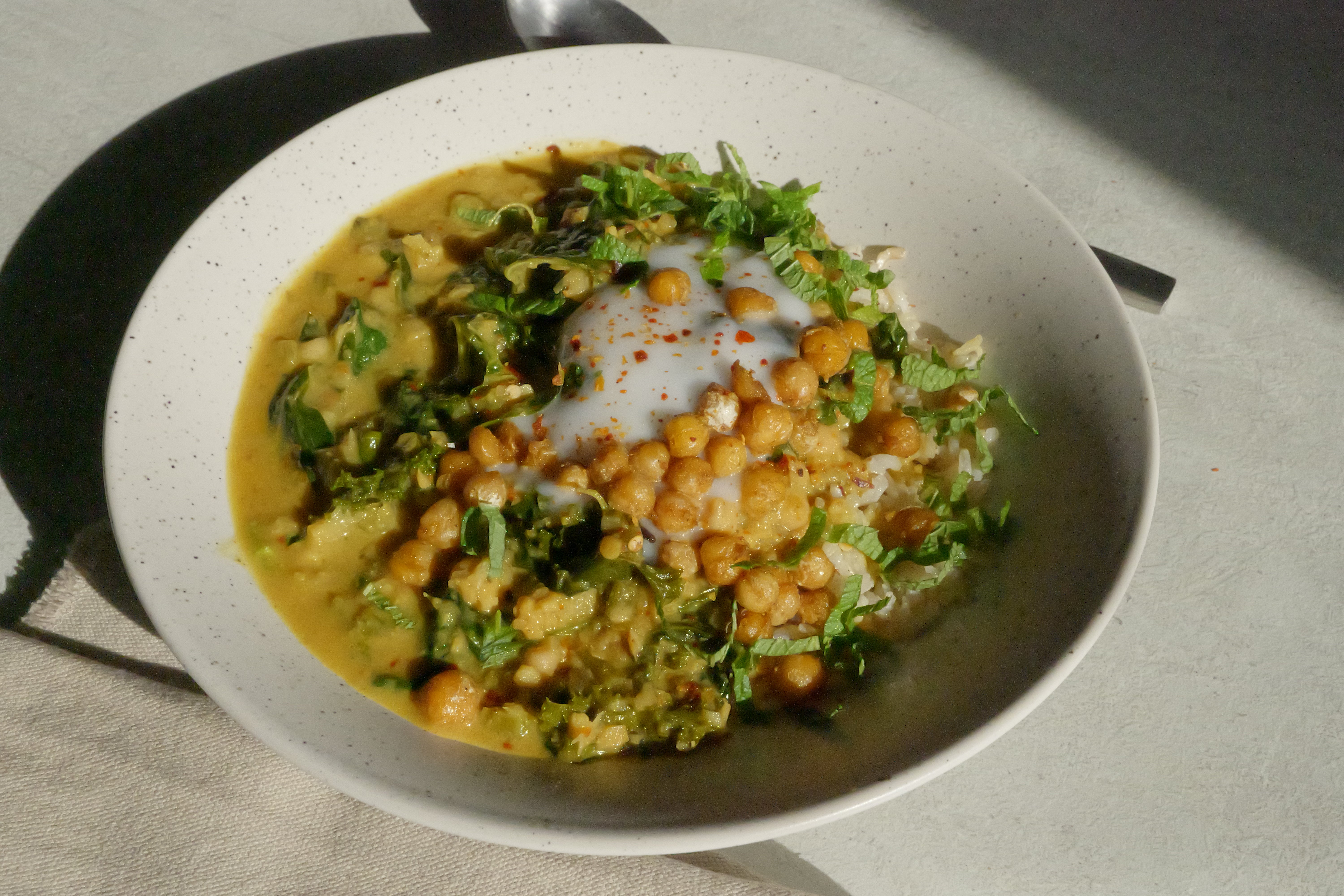 Image of Healing Chickpea Stew with Seasonal Leafy Greens, Wholegrain Basmati Rice, Coconut Yogurt & Anti-Inflammatory Tadka