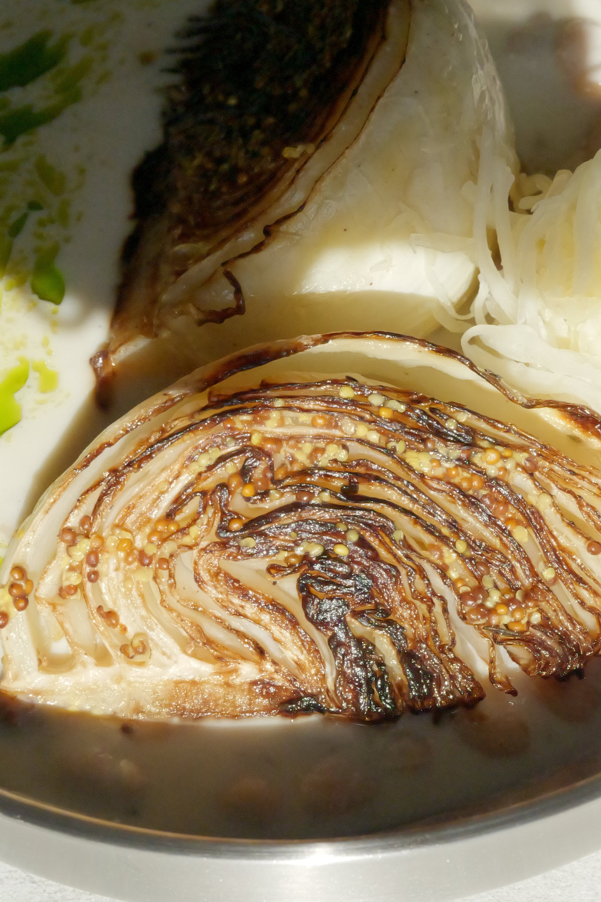 Charred Cabbage with Tofu–Olive Oil Cream, White Beans, Sauerkraut, Parsley Oil & Dijon Mustard
