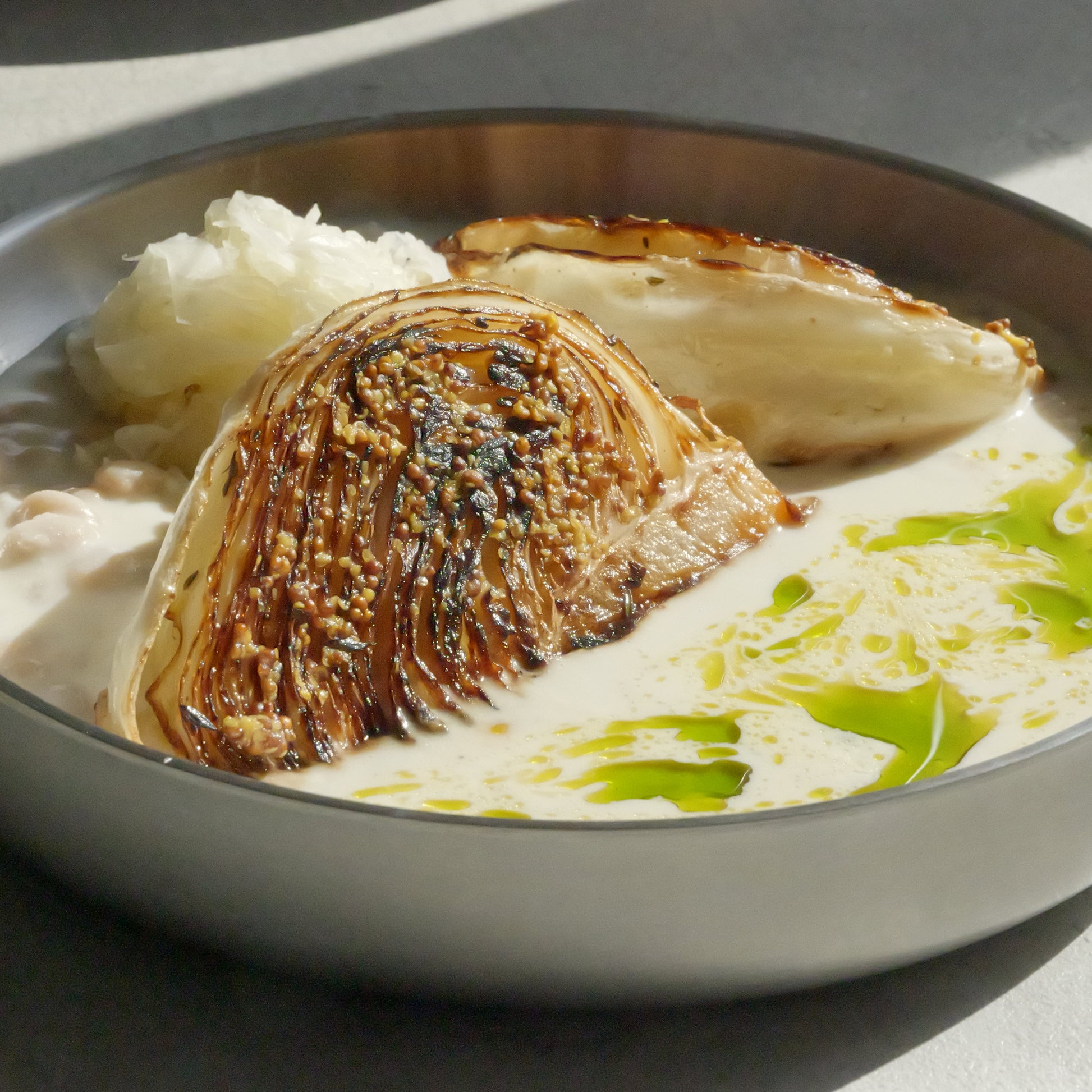 Charred Cabbage with Tofu–Olive Oil Cream, White Beans, Sauerkraut, Parsley Oil & Dijon Mustard
