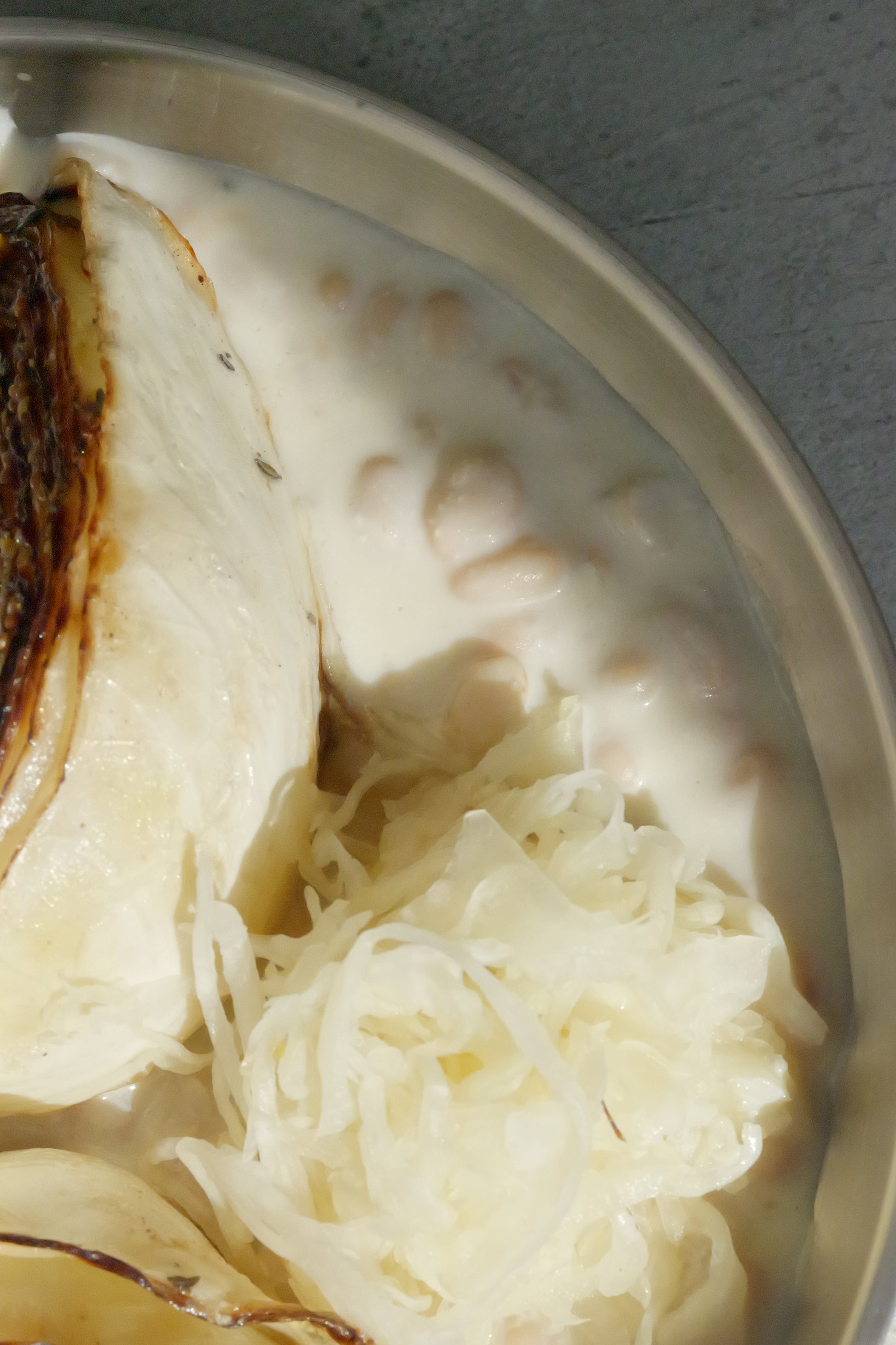 Charred Cabbage with Tofu–Olive Oil Cream, White Beans, Sauerkraut, Parsley Oil & Dijon Mustard
