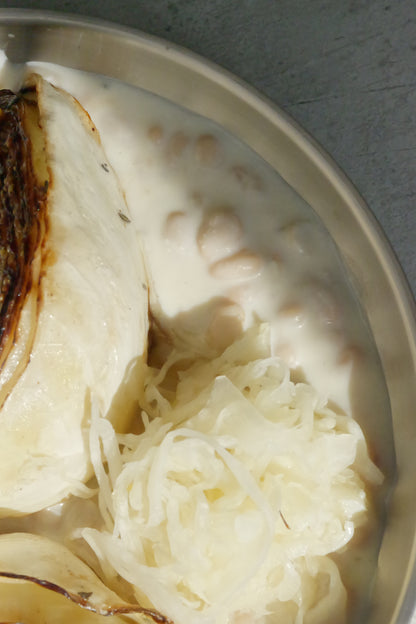 Charred Cabbage with Tofu–Olive Oil Cream, White Beans, Sauerkraut, Parsley Oil & Dijon Mustard
