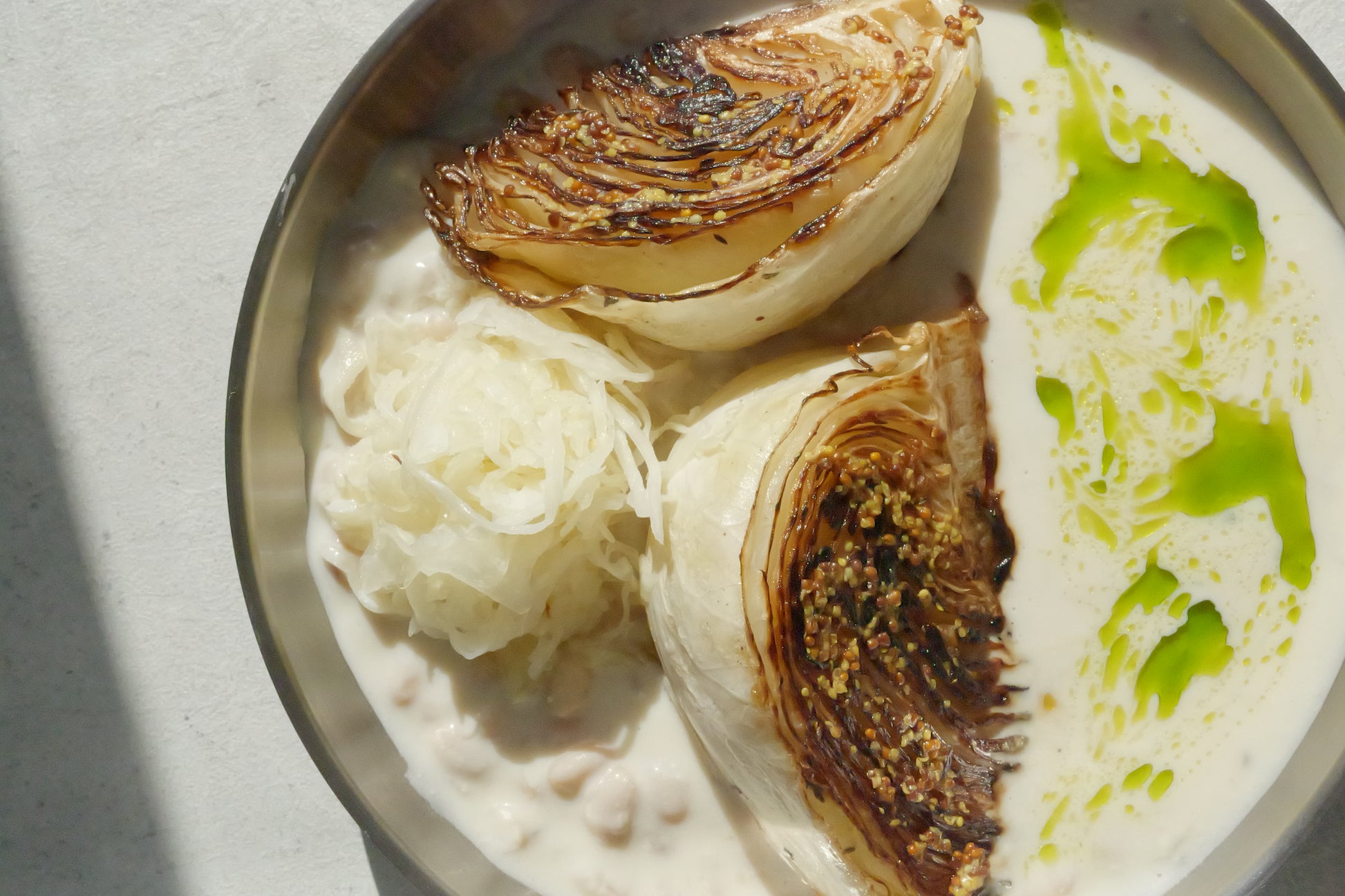 Charred Cabbage with Tofu–Olive Oil Cream, White Beans, Sauerkraut, Parsley Oil & Dijon Mustard