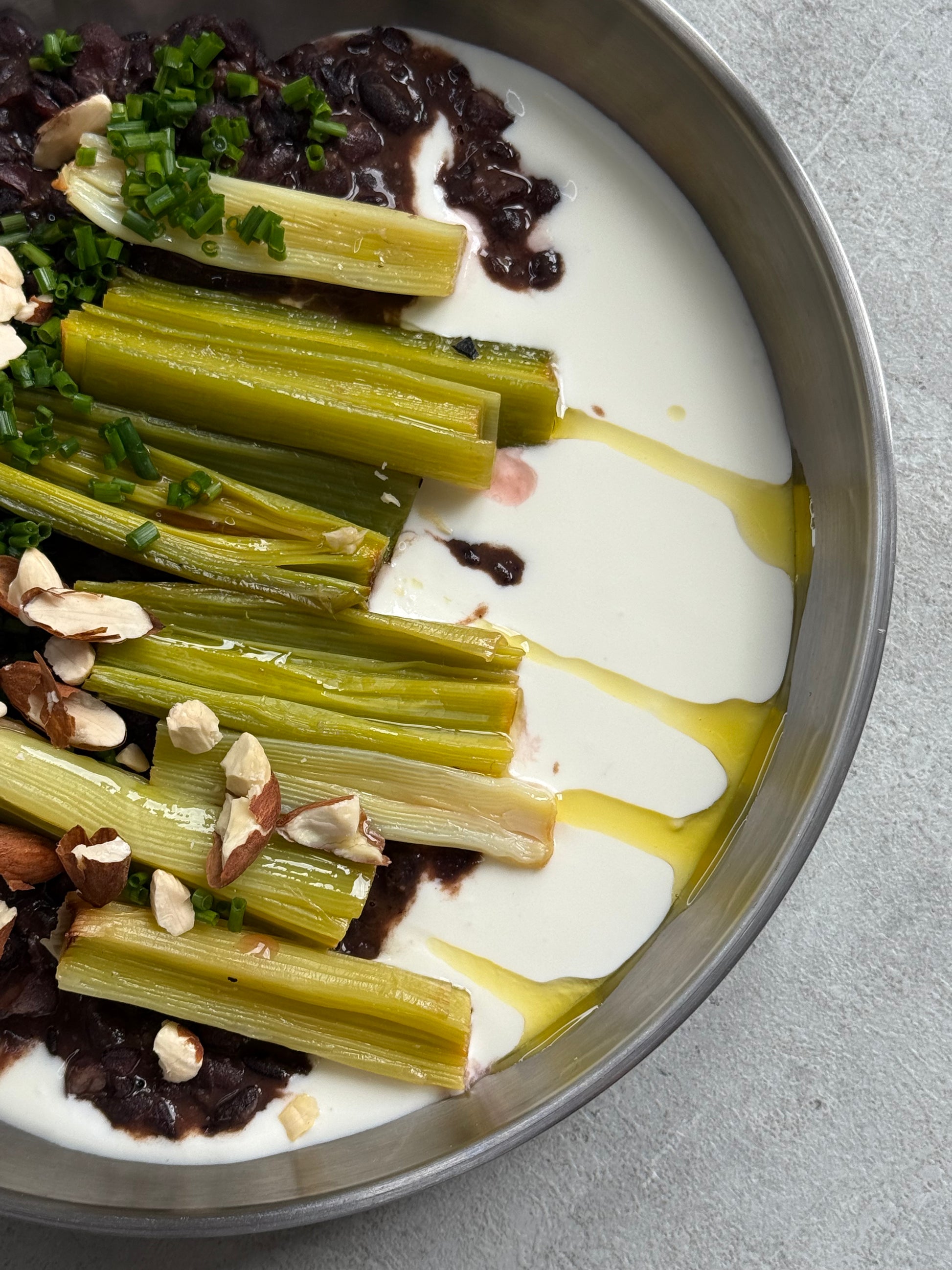 Velvety Cacao & Cumin Black Beans with Sweet Tajine-Style Plums, Charred Leek & Whipped Goat Cheese