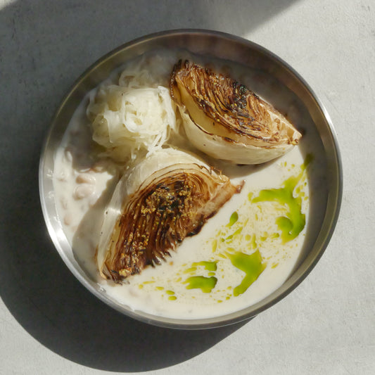 Charred Cabbage with Tofu–Olive Oil Cream, White Beans, Sauerkraut, Parsley Oil & Dijon Mustard