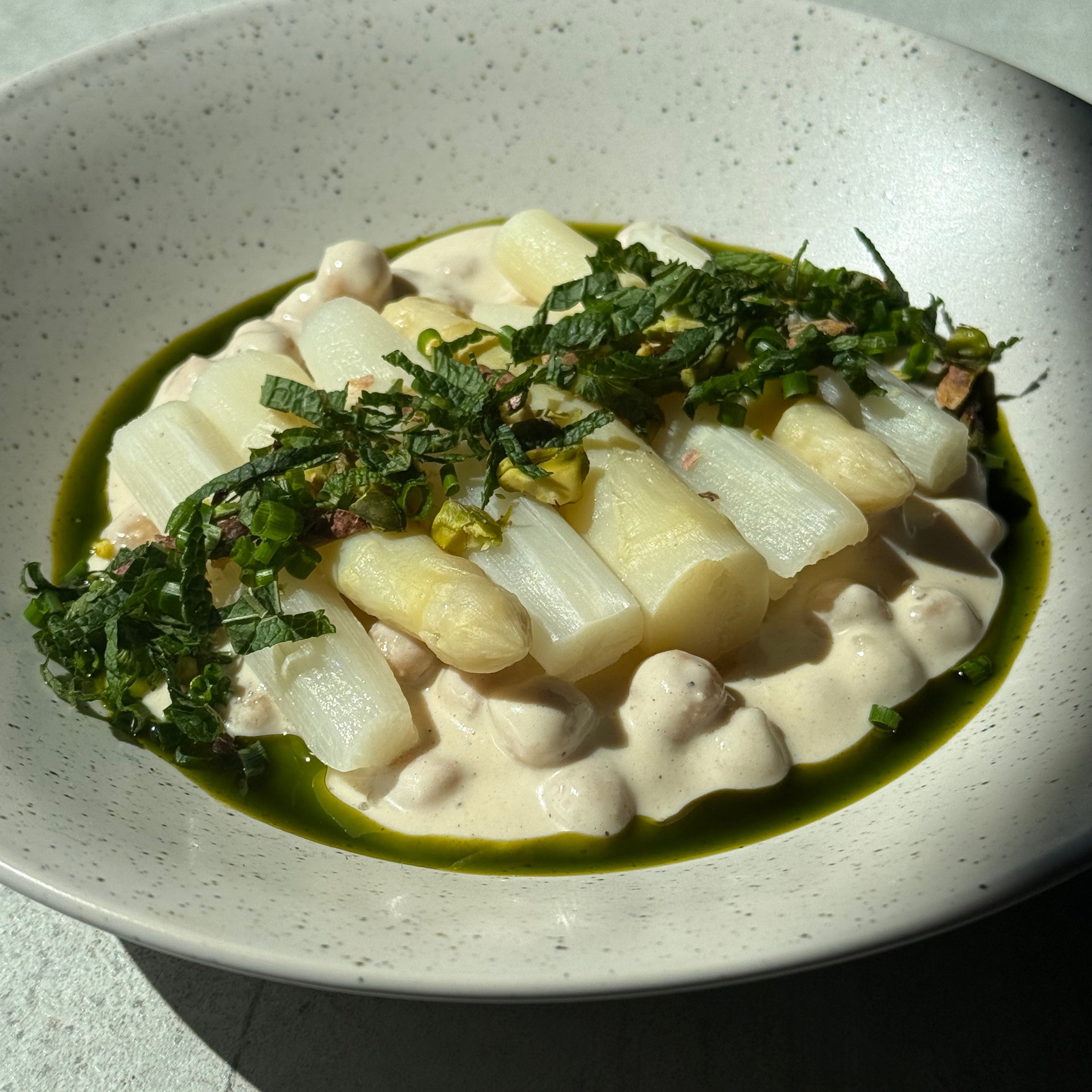 Image of White Asparagus & Chickpeas Umami Glow with Sichuan Potato Salad, Fresh Herbs & Pistachios